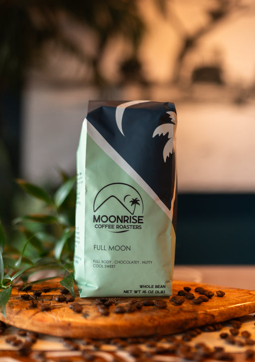 Moonrise Coffee Roasters 'Full Moon' coffee bag on a wooden surface with coffee beans.
